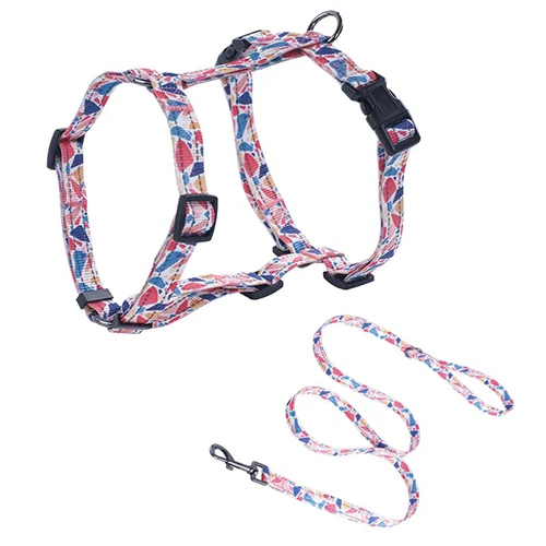 A complete custom dog harness and leash set in a vibrant green pattern.